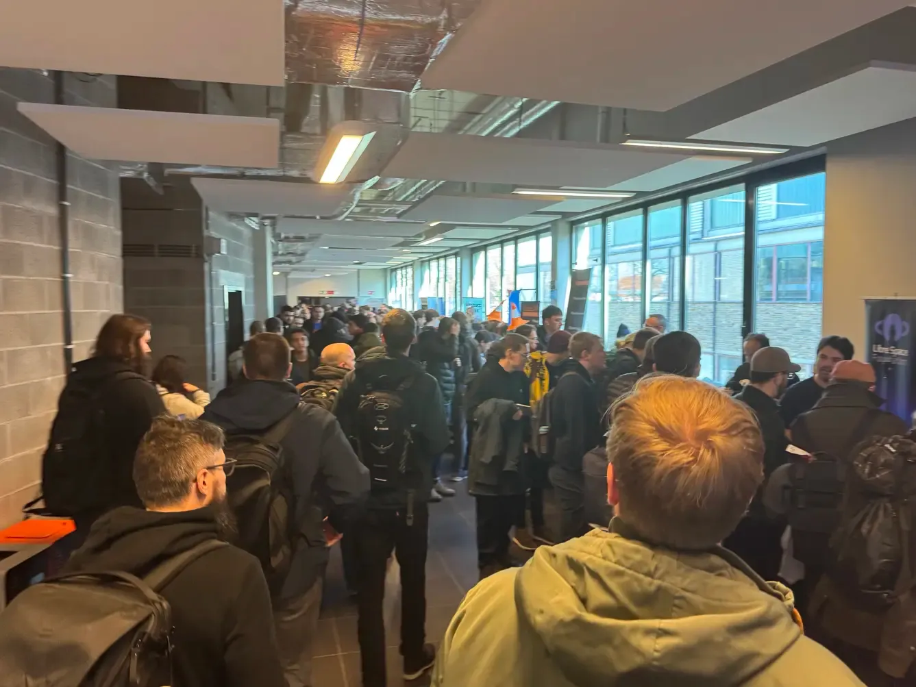 The same corridor as the previous photo except it's now full of people and the stands have been set-up.