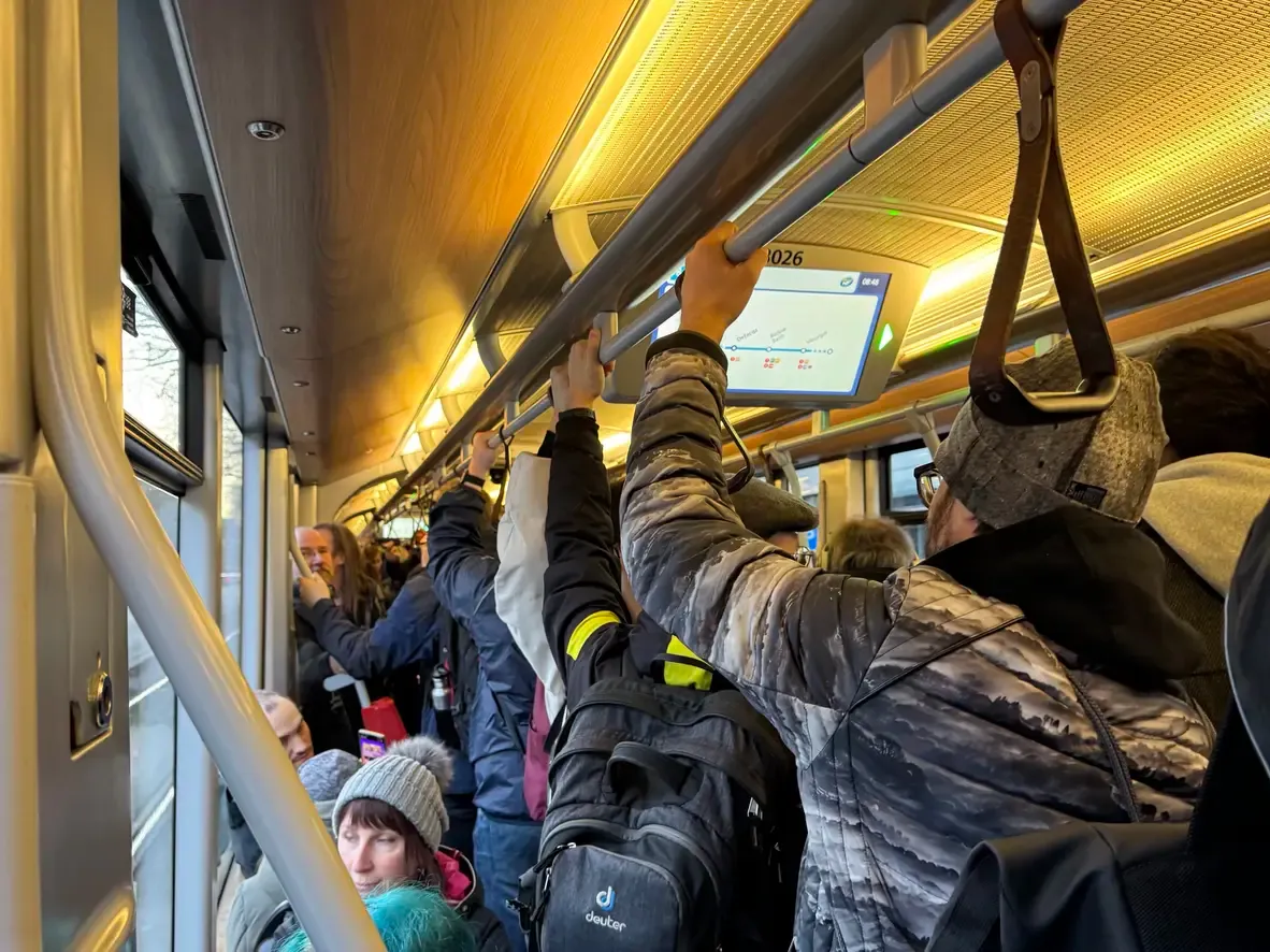 A photo of a very crowded tramway.