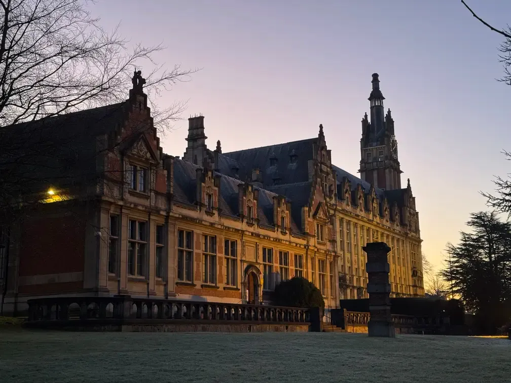 An old building made of bricks, with a very pointy roof.